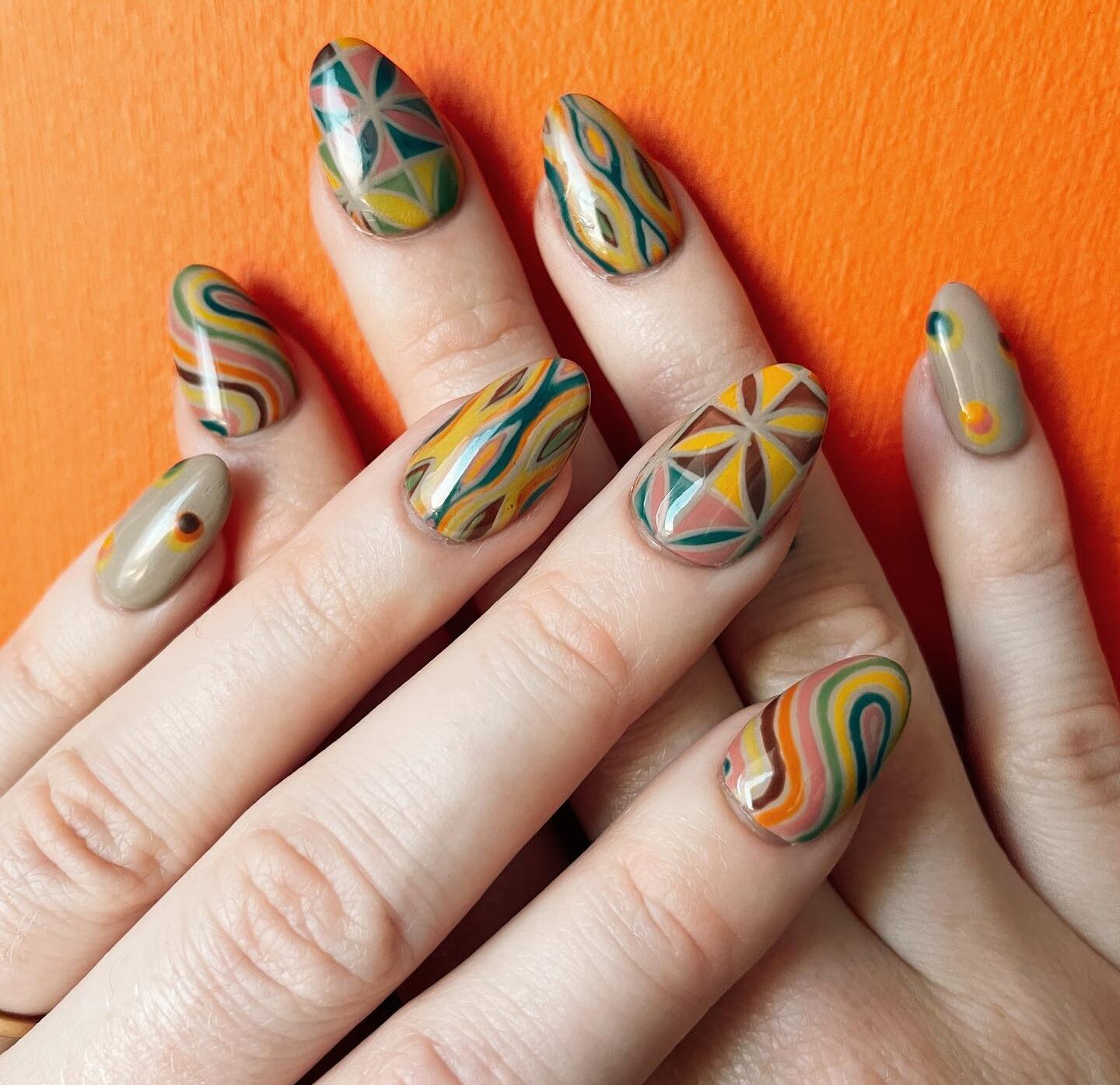 Multicolored abstract nail art on short almond nails