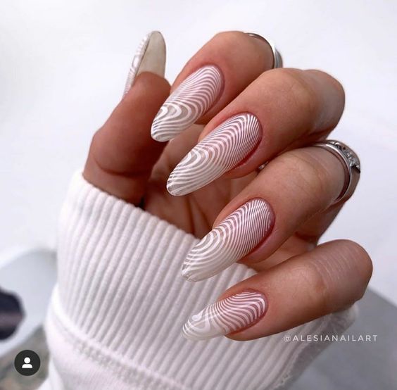 Long round shaped clear nails with white geometric pattern nail art