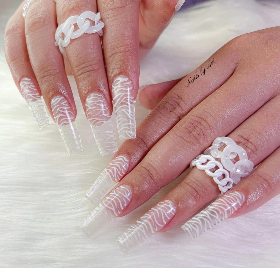 Long square clear nails with white abstract nail art