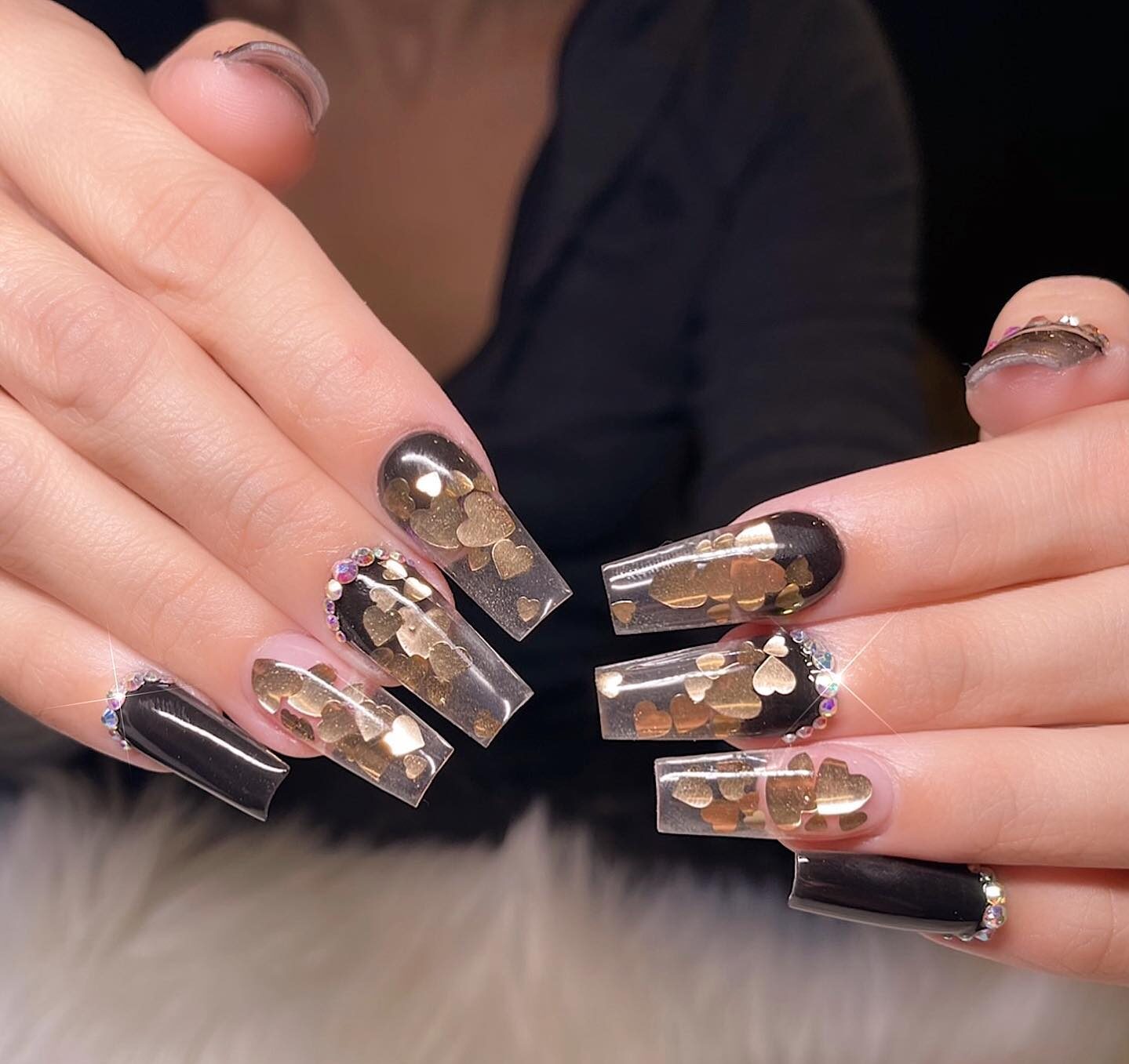 Clear and black nails with rhinestones and gold hearts mail arts