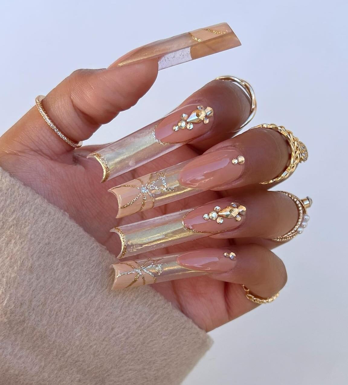 Combination of clear and gold French tips with rhinestones on super long square nails