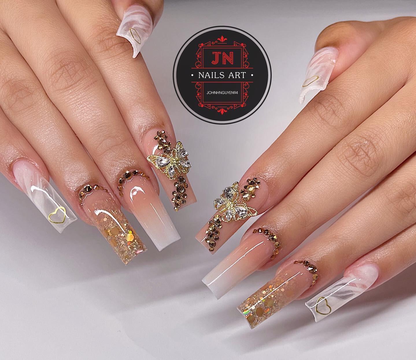 Glossy finish nude ombre and clear and white marble nail designs with 3D bling and gold glitters