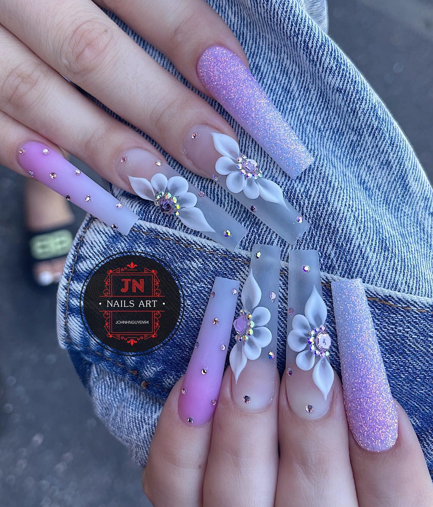 Lavender ombre effect with glitters, rhinestones, and 3D floral nail arts on super long coffin shaped clear nails