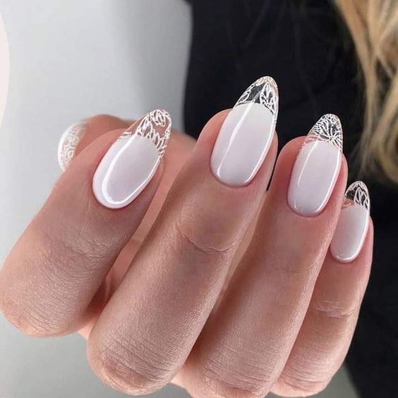 White nail polish and clear French tips with abstract design