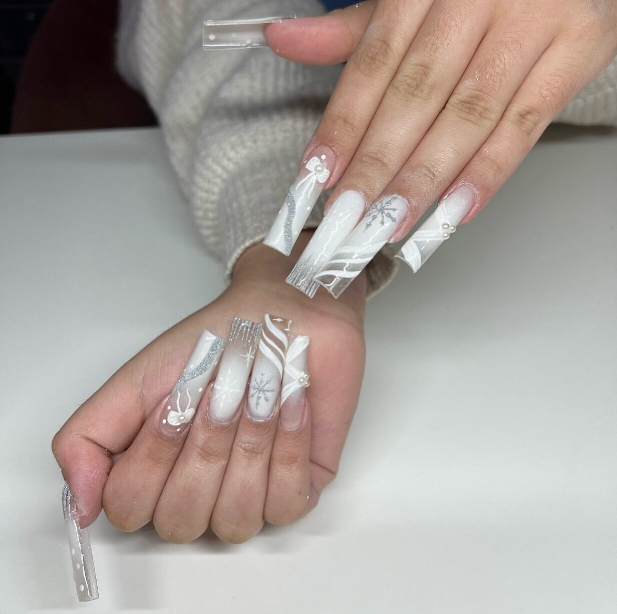 Super long white and clear nails with snowflakes and winter nail designs