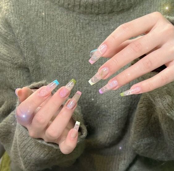 Long tapered square clear nails with colorful French tips and white hearts nail designs