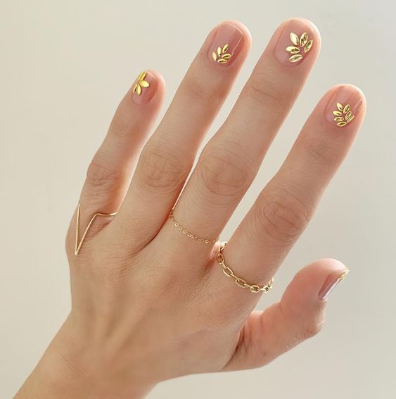 Short natural clear nails with gold leaves nail art