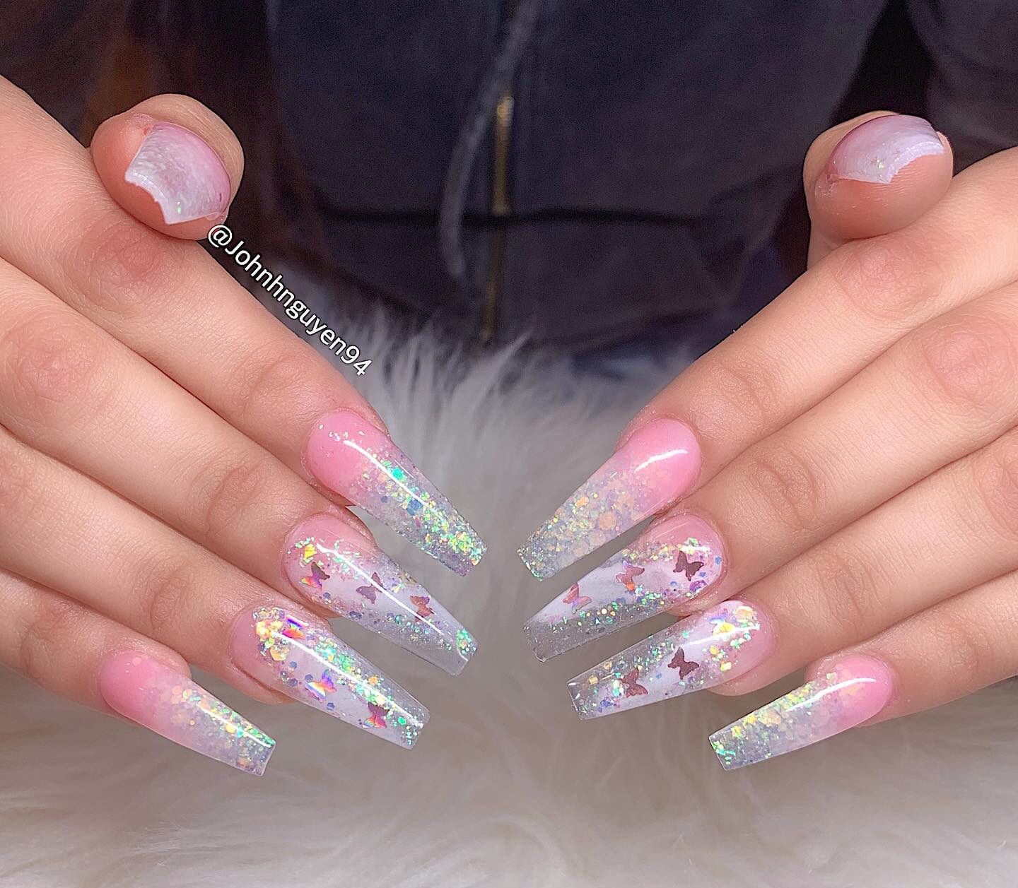 Long coffin shaped clear nails with glitters and pink butterflies nail designs