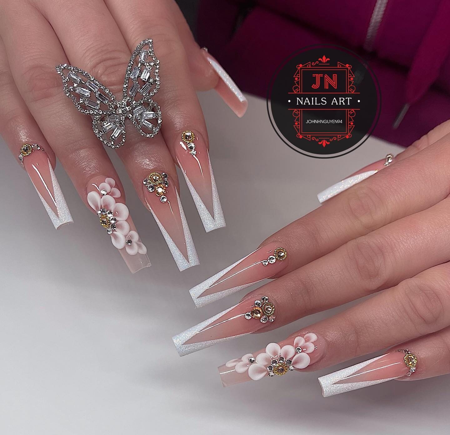 Super long tapered square clear nails with slanted French tips, rhinestones, and 3D flowers nail arts