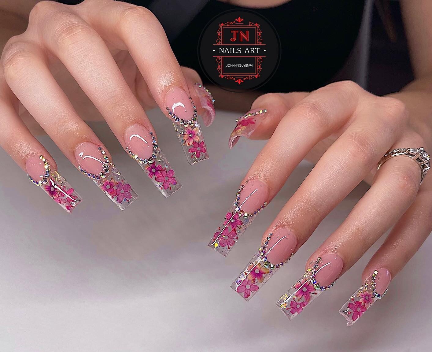 Dainty pink flowers and rhinestones on long tapered square clear nails