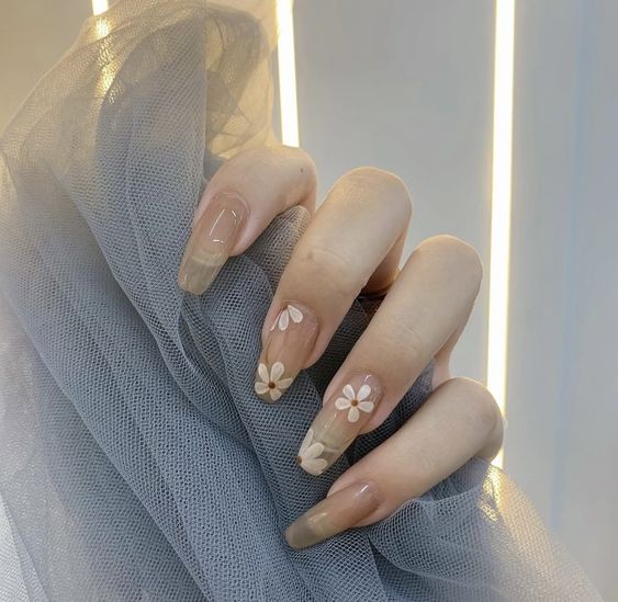 Coffin shaped clear nails with white flowers nail art