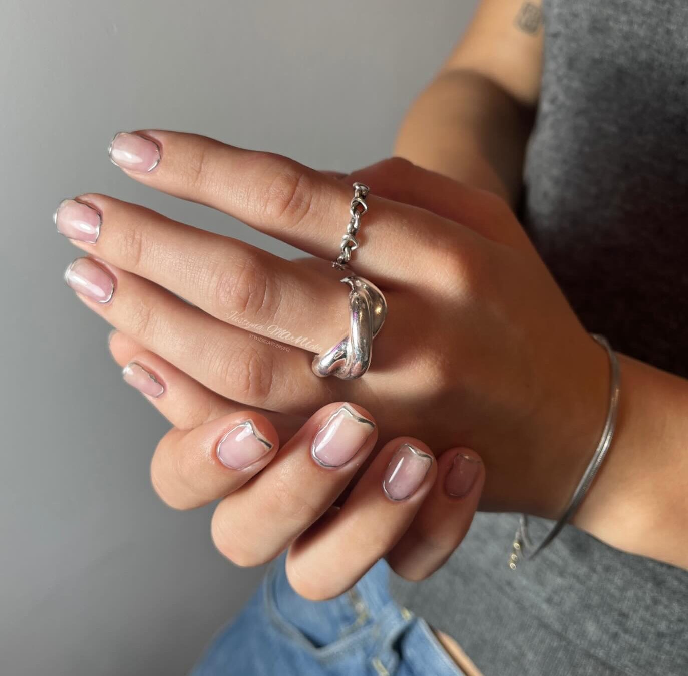 Short natural clear nails with silver outlines nail art