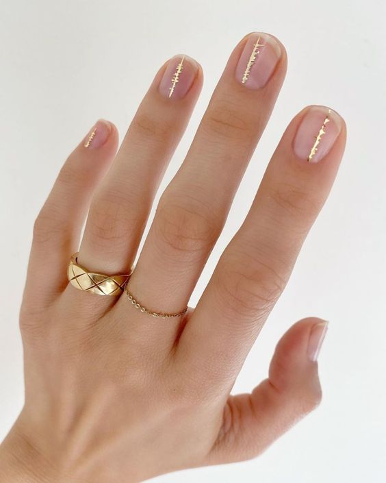 Short natural clear nails with gold lines accents