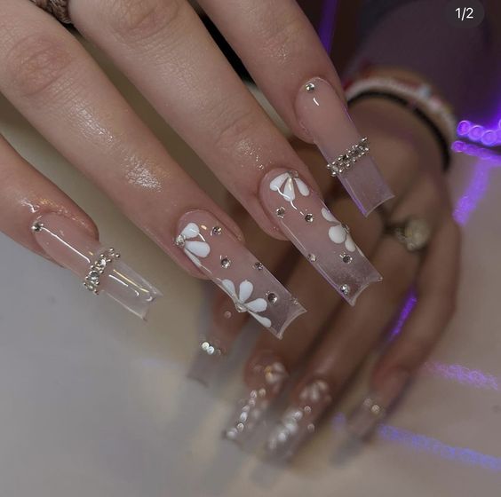 Nude to clear ombre effect with rhinestones and flower nail arts on super long square nails