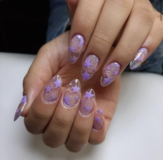 Long round shaped clear nails with purple stars nail art