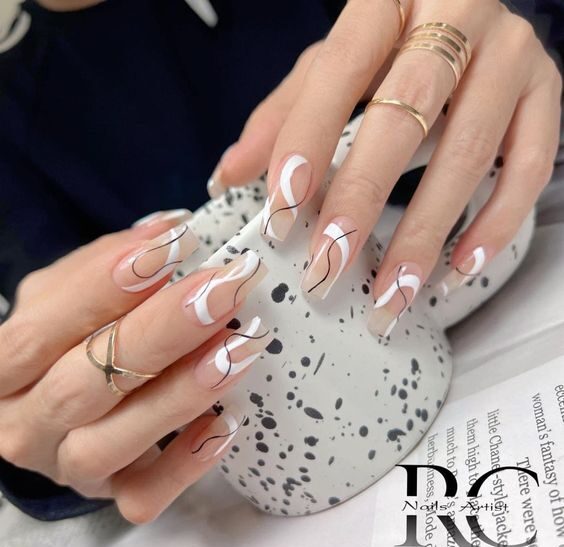 Clear tapered square nails with black and white swirling patterns