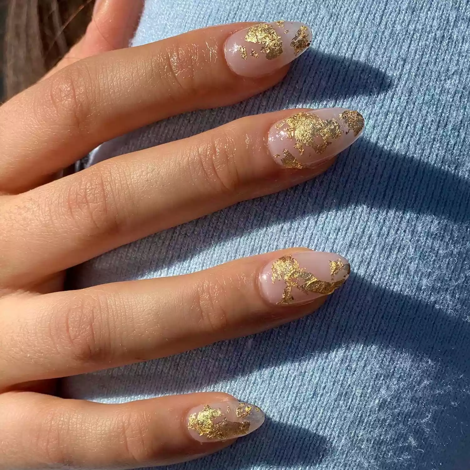 Manicure with clear base and gold foil design