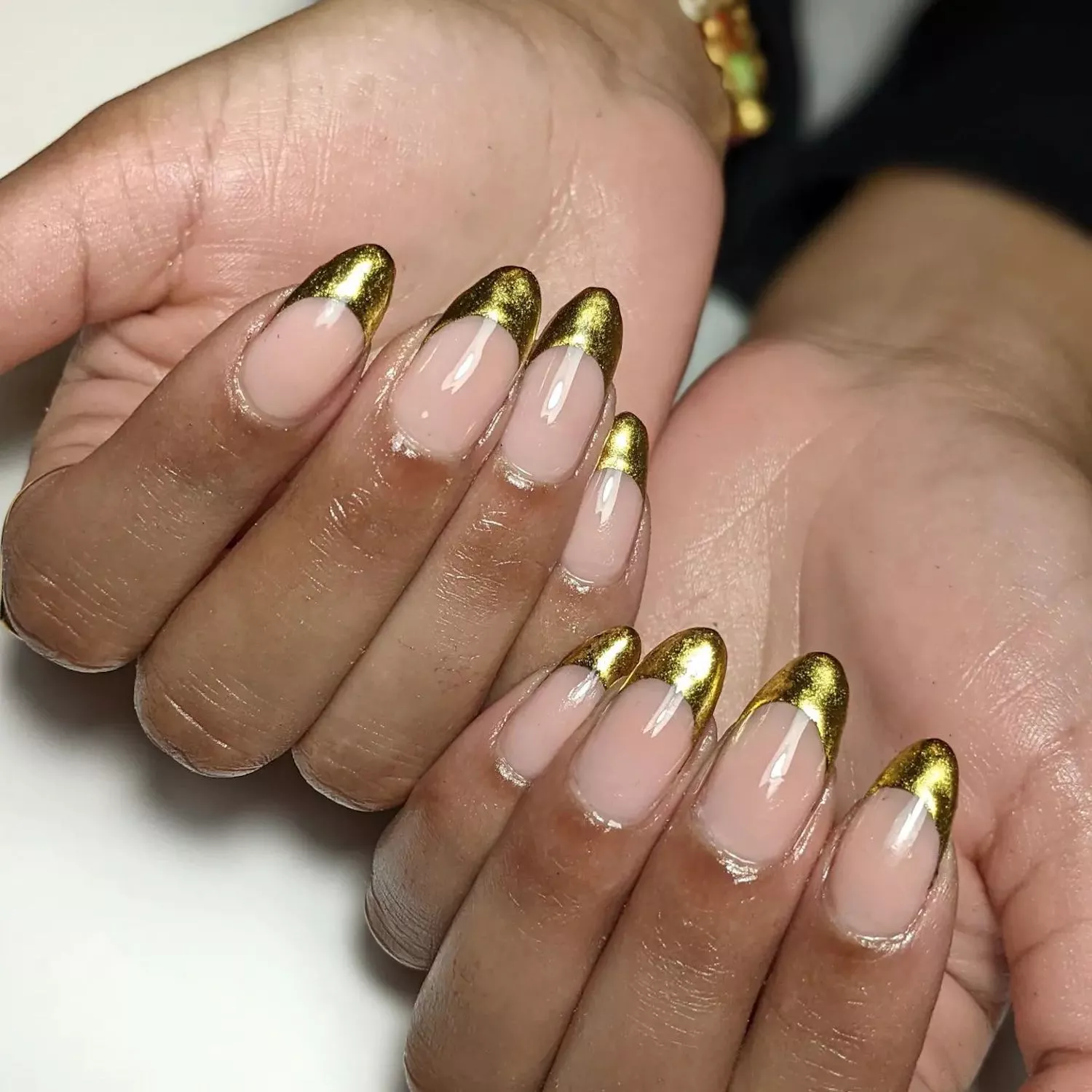 Manicure with gold French tips and ultra-glossy top coat