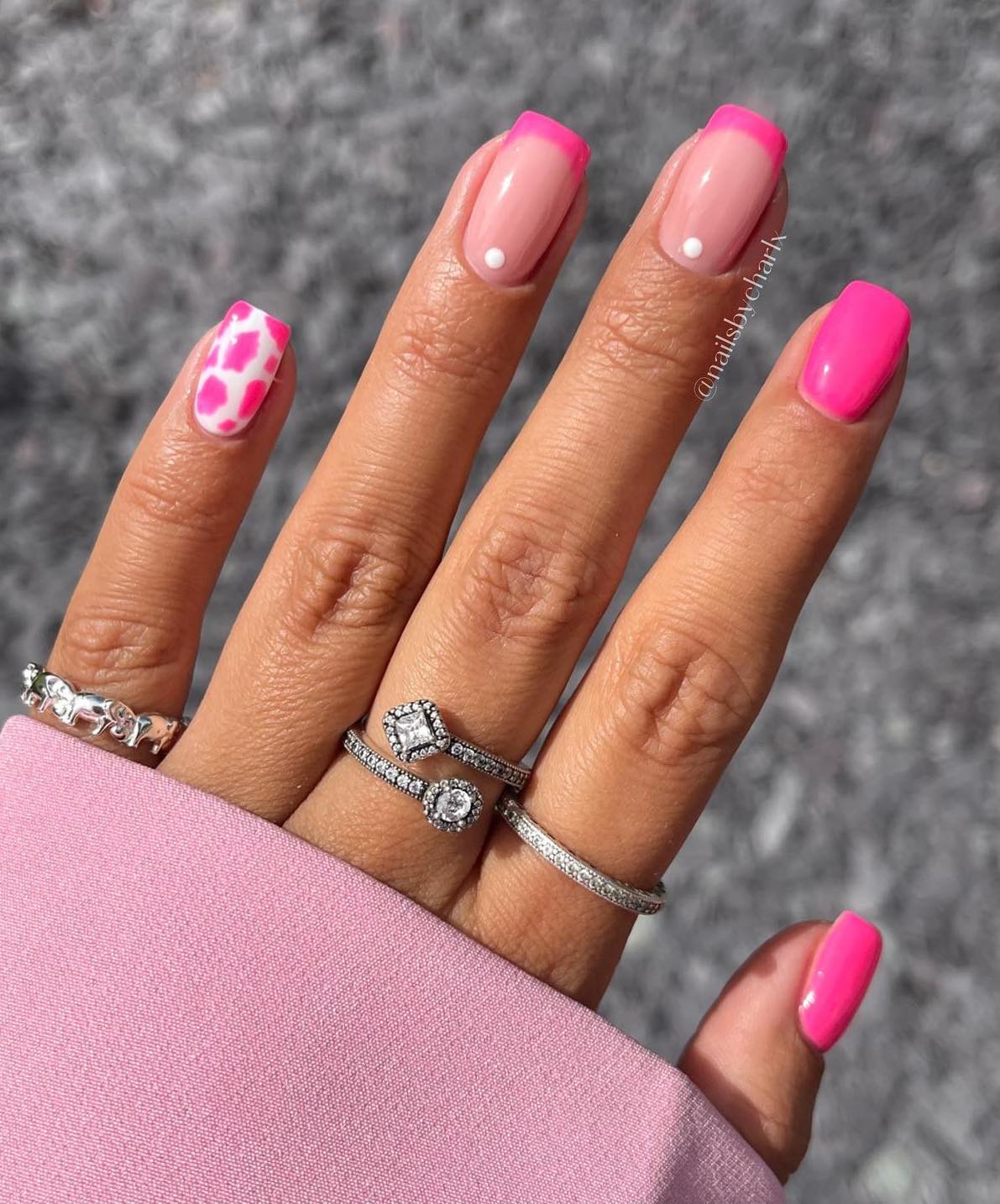 Hot pink nails with French tips and cow print.