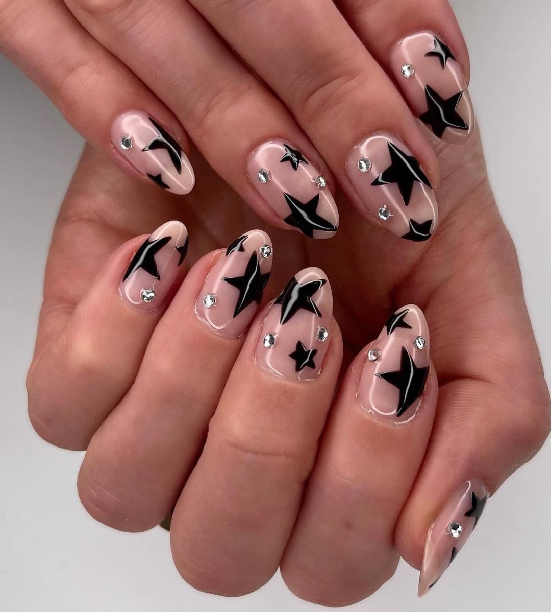 Glossy black star nails.