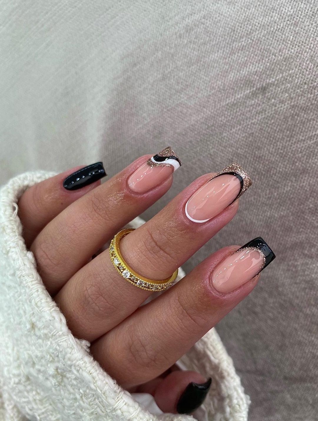 Black and gold French tip nails.