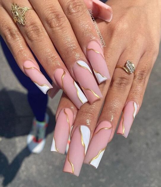 Pink and white swirls with gold outline on long square acrylic nails