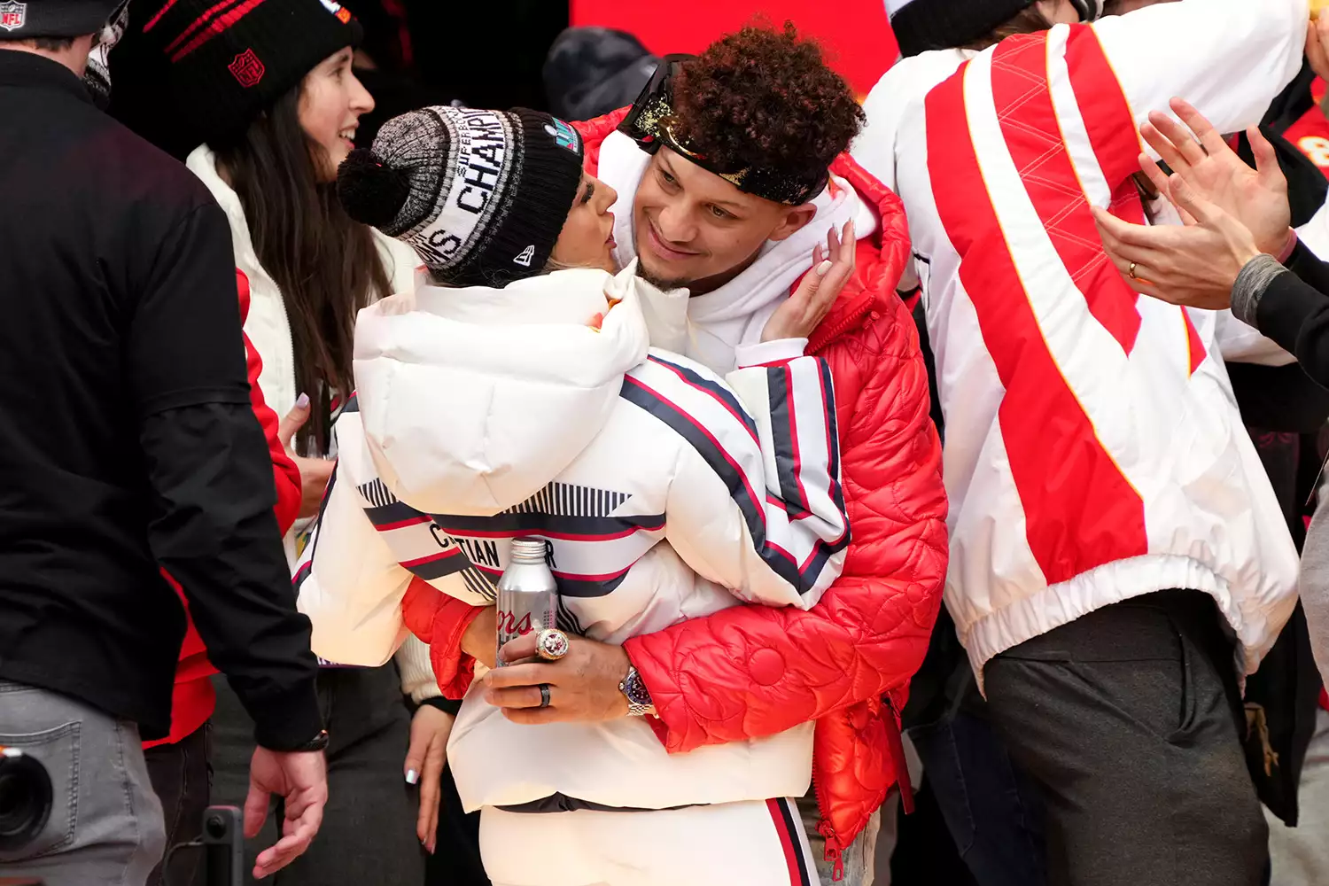 Patrick Mahomes #15 of the Kansas City Chiefs and wife Brittany Mahomes celebrate on stage during the Kansas City Chiefs Super Bowl LVII victory parade