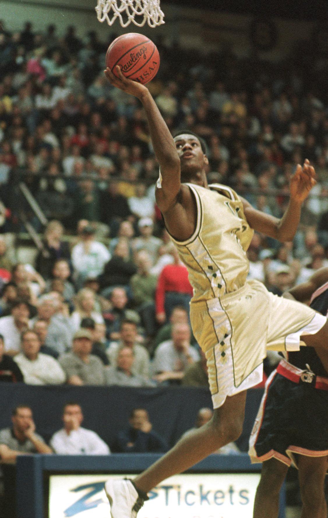 LeBron James of Akron St. Vincent-St. Mary High School drives to the basket or two points during the third quarter against Akron Central Hower, in Akron, Sunday, Feb. 25, 2001. St. V-St. M won the game 70-60. (PHIL LONG/SPECIAL TO THE PLAIN DEALER)