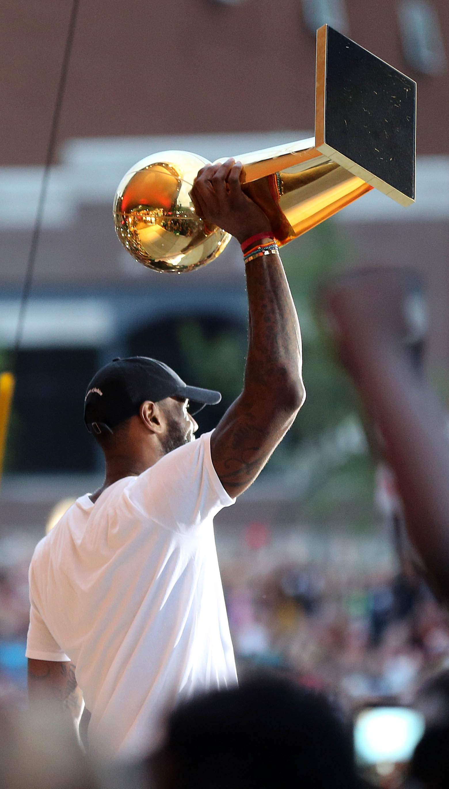 Cleveland Cavaliers forward LeBron James hoists the Larry O'Brien trophy at a rally to honor him after winning the NBA championship and MVP award.   Joshua Gunter, cleveland.com.  June 23, 2016. Akron.