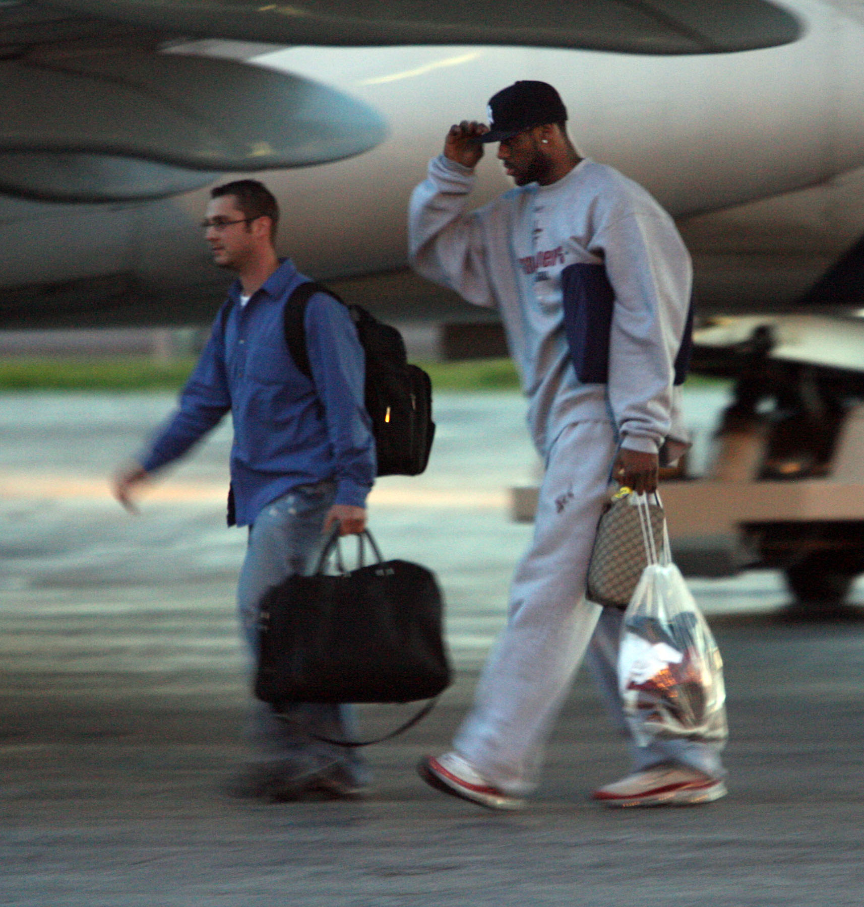 Cleveland Cavaliers player LeBron James walks off the plane in Cleveland after their loss to Detroit Sunday. Man in front is unknown.  Photo taken May 21, 2006.  (Scott Shaw/The Plain Dealer)