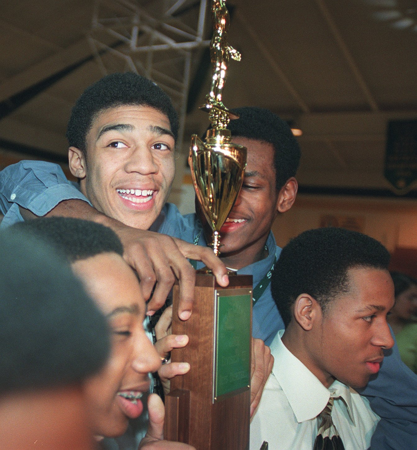 Romeo Travis was all smiles Wednesday afternoon as he held the SVSM state basketball trophy during a rally honoring the team, the cheerleaders, and the state champ wrestling team.  Behind trophy at right is LeBron James.  Wednesday  March 28, 2001  (Bill Kennedy/The Plain Dealer)