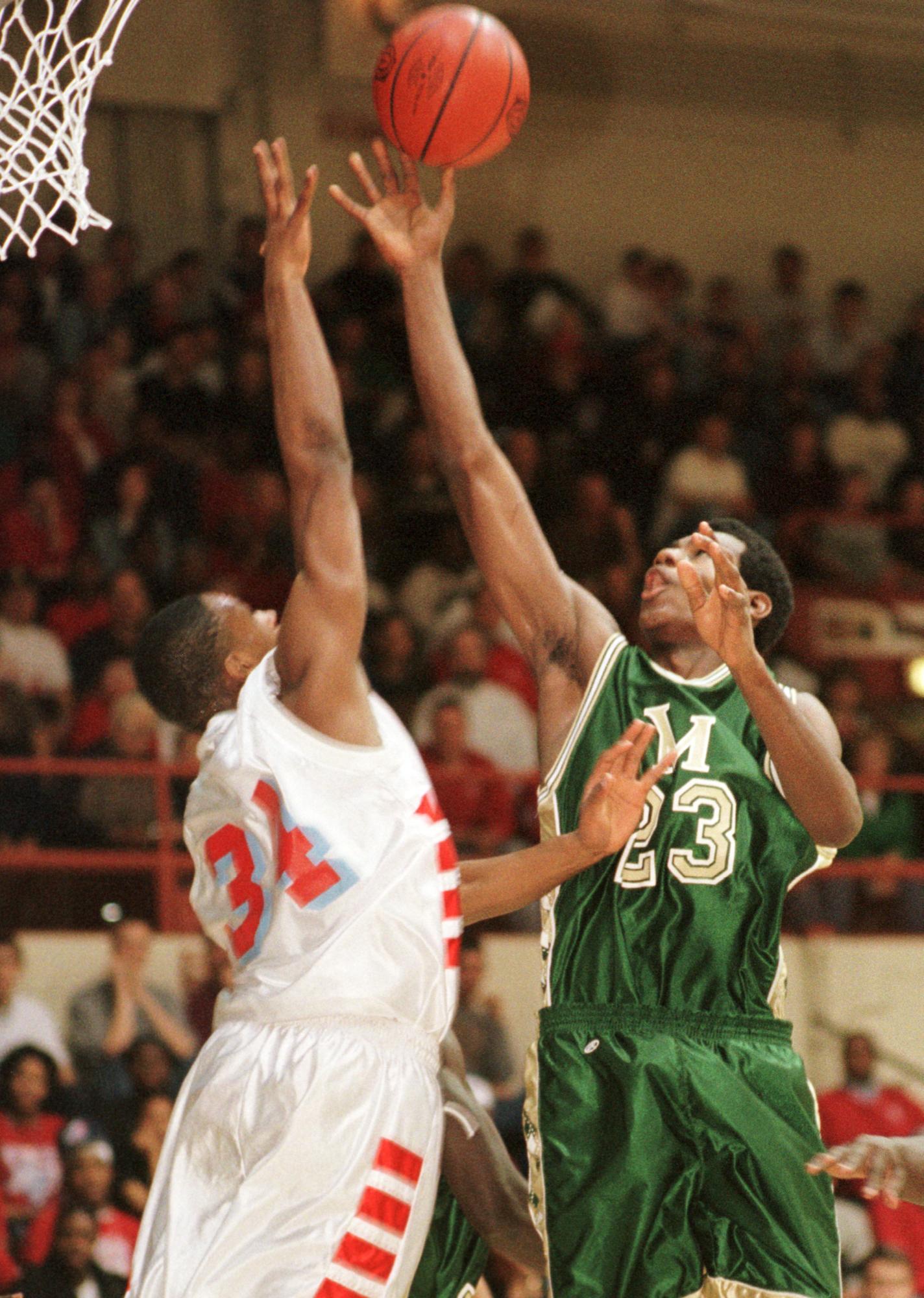 LeBron James (23) of St. Vincent-St. Mary High School gets a shot over Villa-Angela/St. Joseph defender Steve Pryor during the third quarter of the Div. III Regional Championship in Canton, Saturday, March 17, 2001. St. V-St. M won the game 71-42.(PHIL LONG/SPECIAL TO THE PLAIN DEALER)