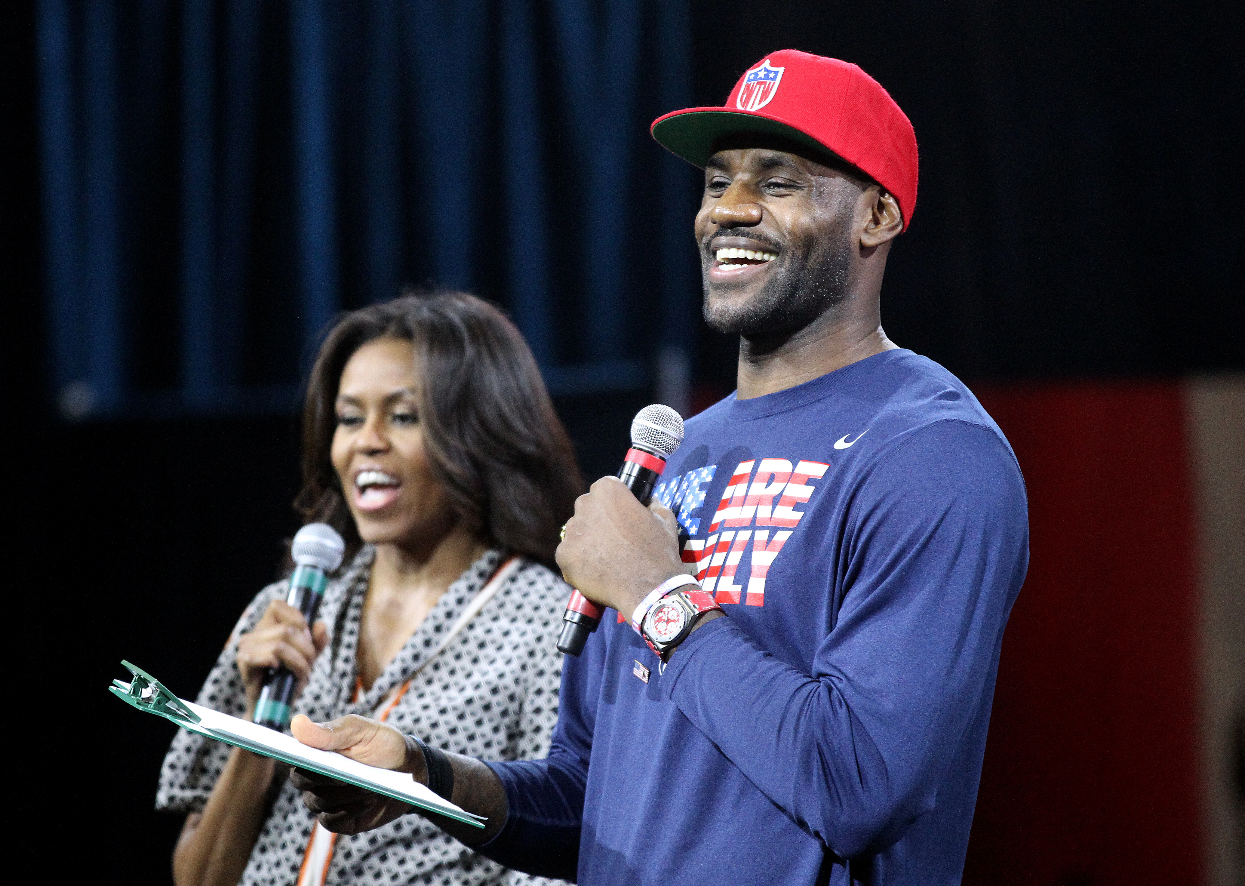 Cleveland Cavalier LeBron James, joined by First Lady Michelle Obama, reads a pledge to students from the LeBron James Family FoundationÕs Wheels for Education and Akron I PROMISE Network programs at the James A. Rhodes Arena at the University of Akron on Wednesday, Oct. 21, 2015. As part of her Reach Higher efforts, the First Lady highlights the importance of post-secondary education. Earlier this year, the LeBron James Family Foundation and The University of Akron announced a financial commitment to cover college education for thousands of the programÕs qualified students. (Lisa DeJong/The Plain Dealer)