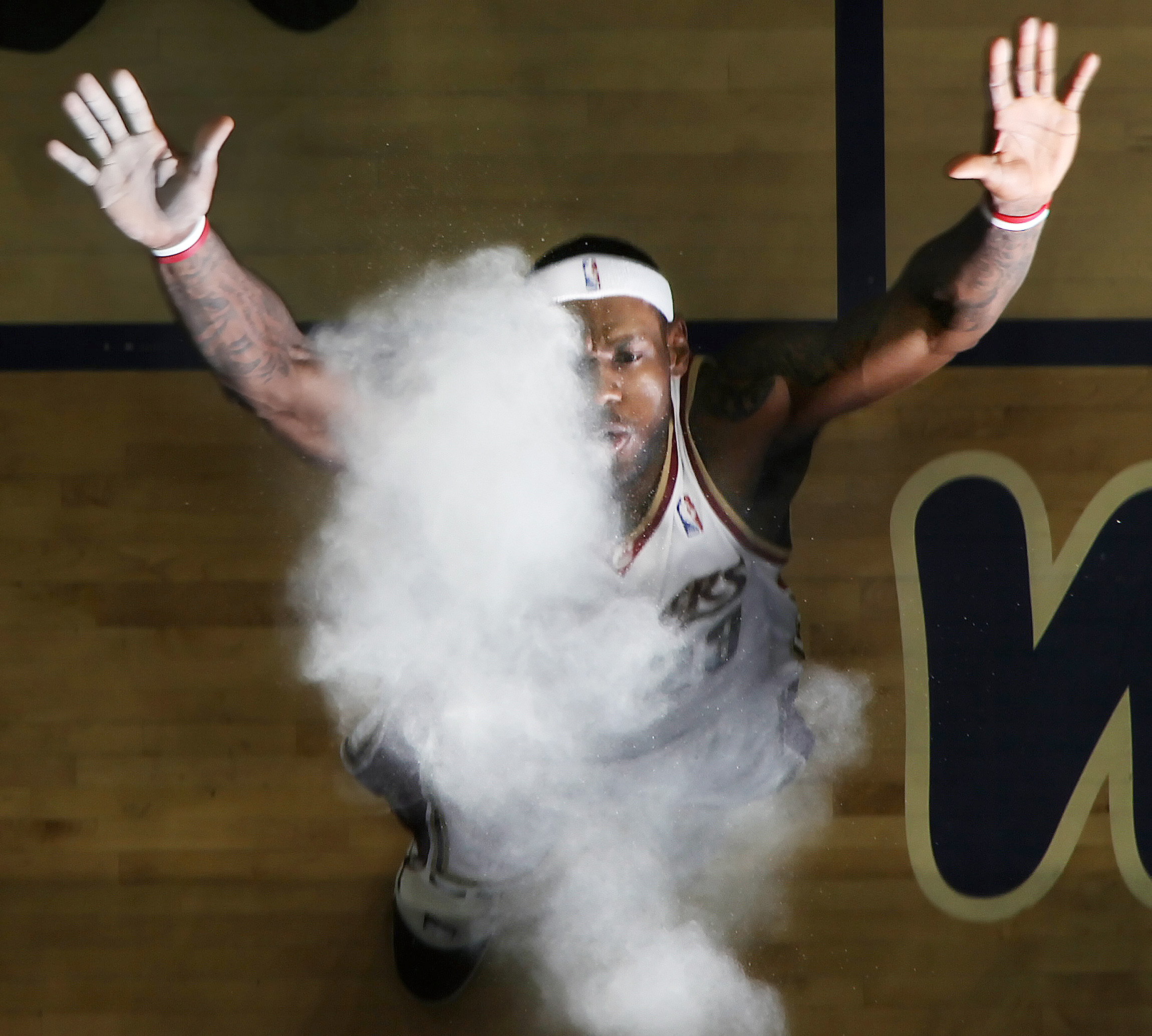 Cleveland Cavaliers LeBron James performs his pregame ritual of throwing up a handful of talc powder and blowing up in the air May 20, 2009 during the first game of the Eastern Conference Finals against the Orlando Magic at Quicken Loans Arena.  (John Kuntz / The Plain Dealer)