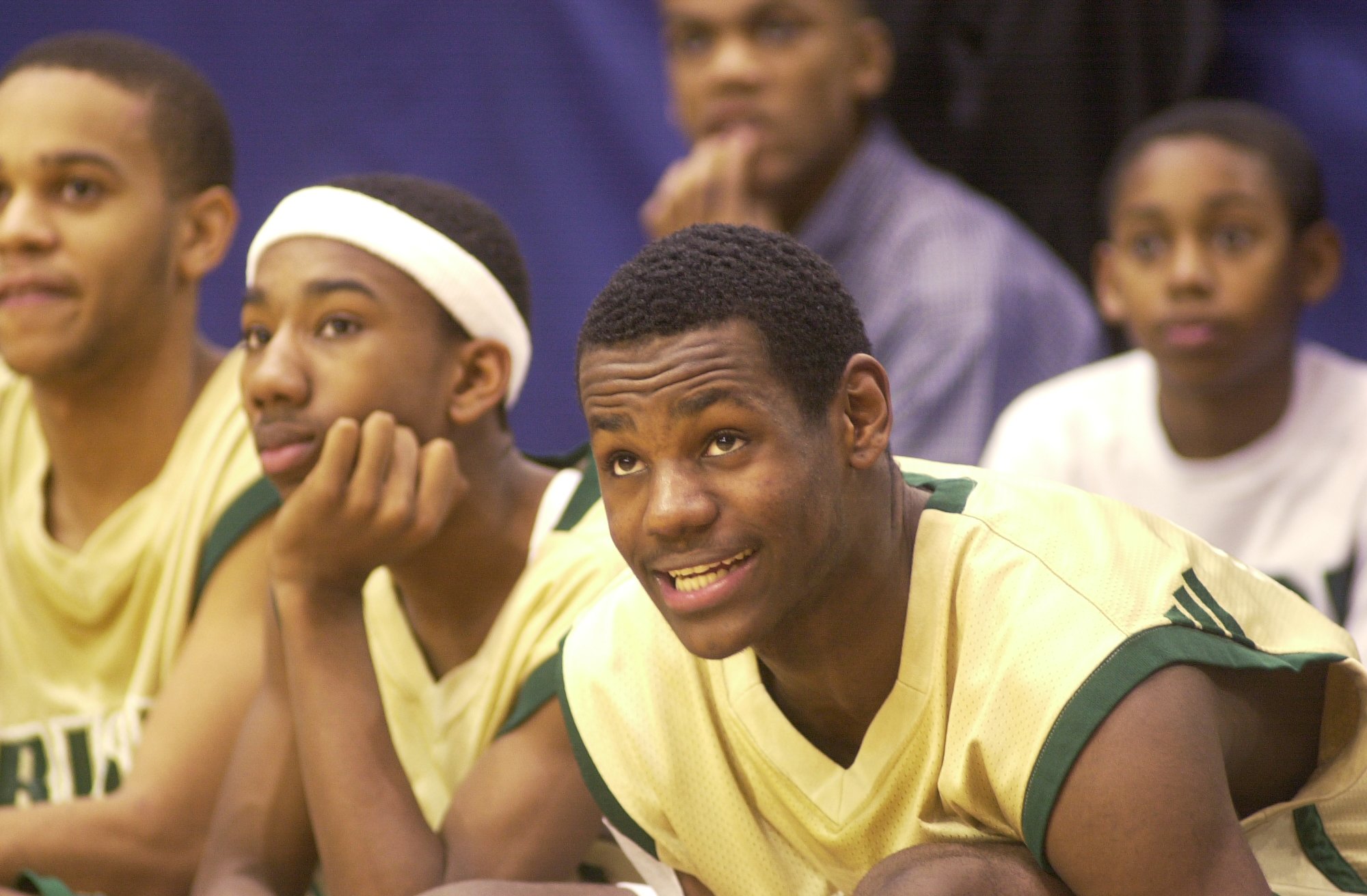 LeBron James watches his team from the bench last Friday with his friend Dru Joyce Jr. at his left.  .Friday January 11, 2002 (Bill Kennedy/The Plain Dealer)