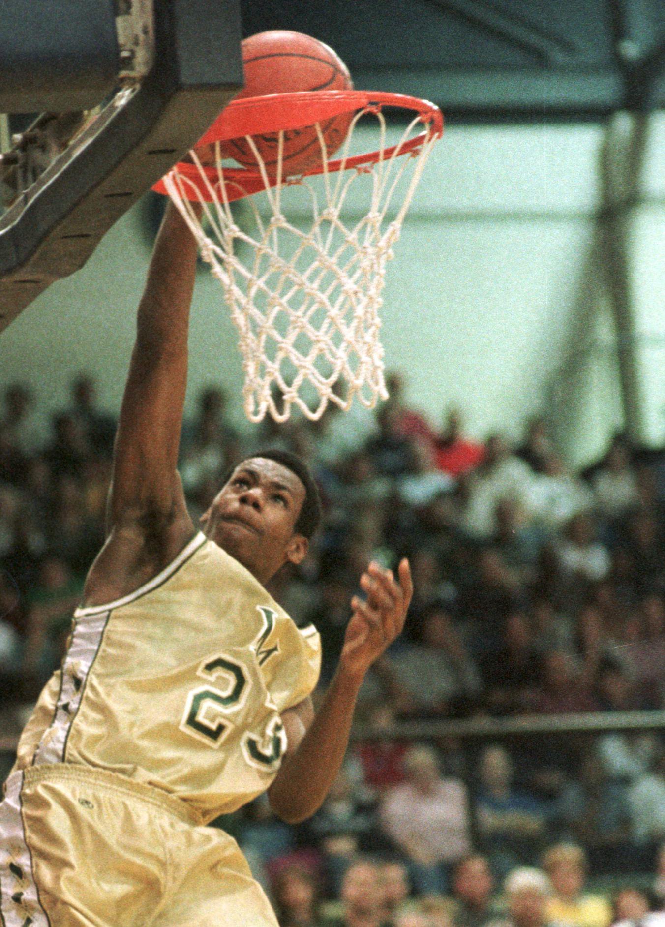 LeBron James of Akron St. Vincent-St. Mary High School slams home two points during the first quarter against Akron Central-Hower Sunday in Akron. St. V-St.M won the game 70-60.  (PHIL LONG/SPECIAL TO THE PLAIN DEALER)