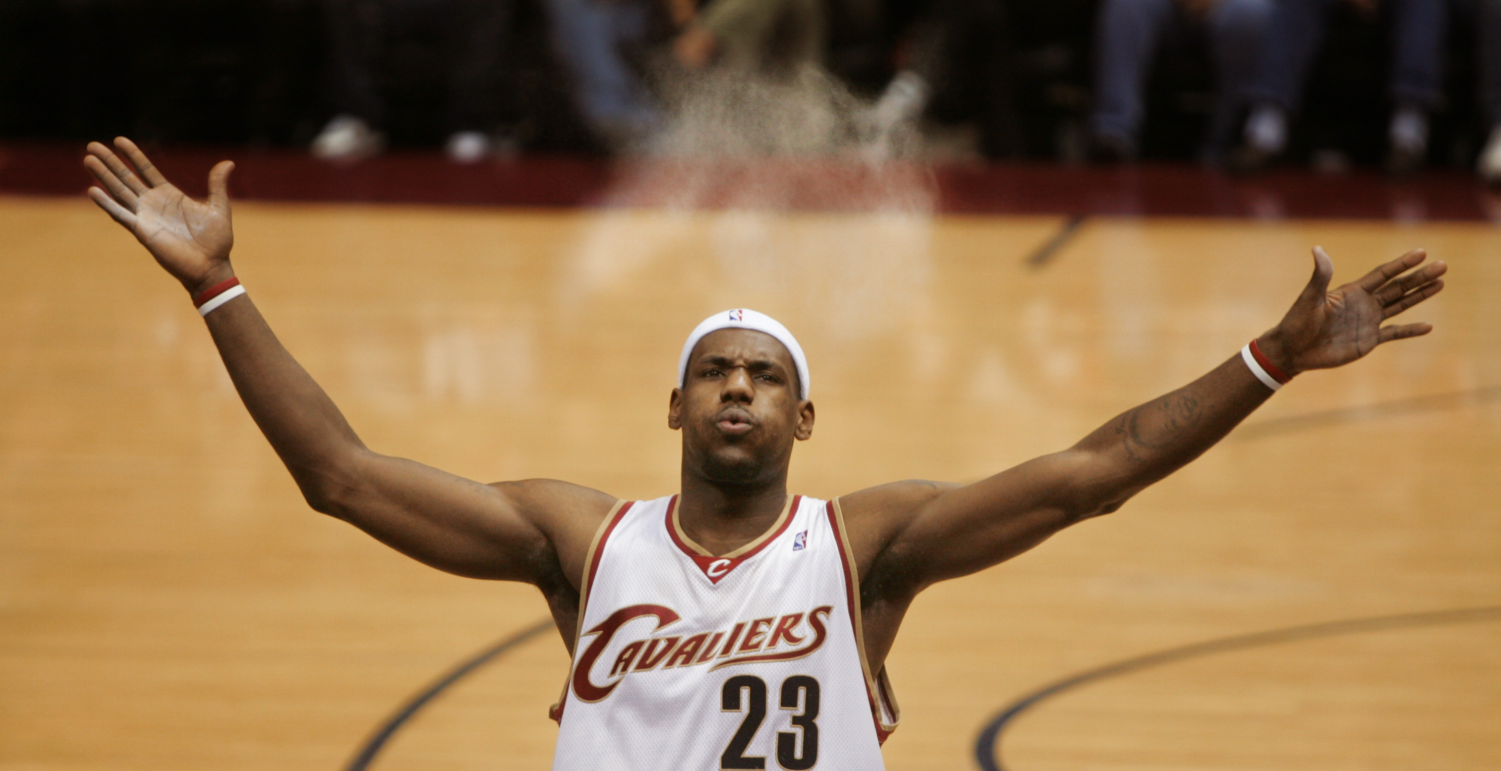 The Cleveland Cavaliers LeBron James sends talc powder in the air as he blows it away from his face before a game against the Orlando Magic February 21, 2006 at Quicken Loans Arena.  The powder blast is a pre-game ritual for LeBron and the first row of media usually gets some of the residue.   (John Kuntz/The Plain Dealer)