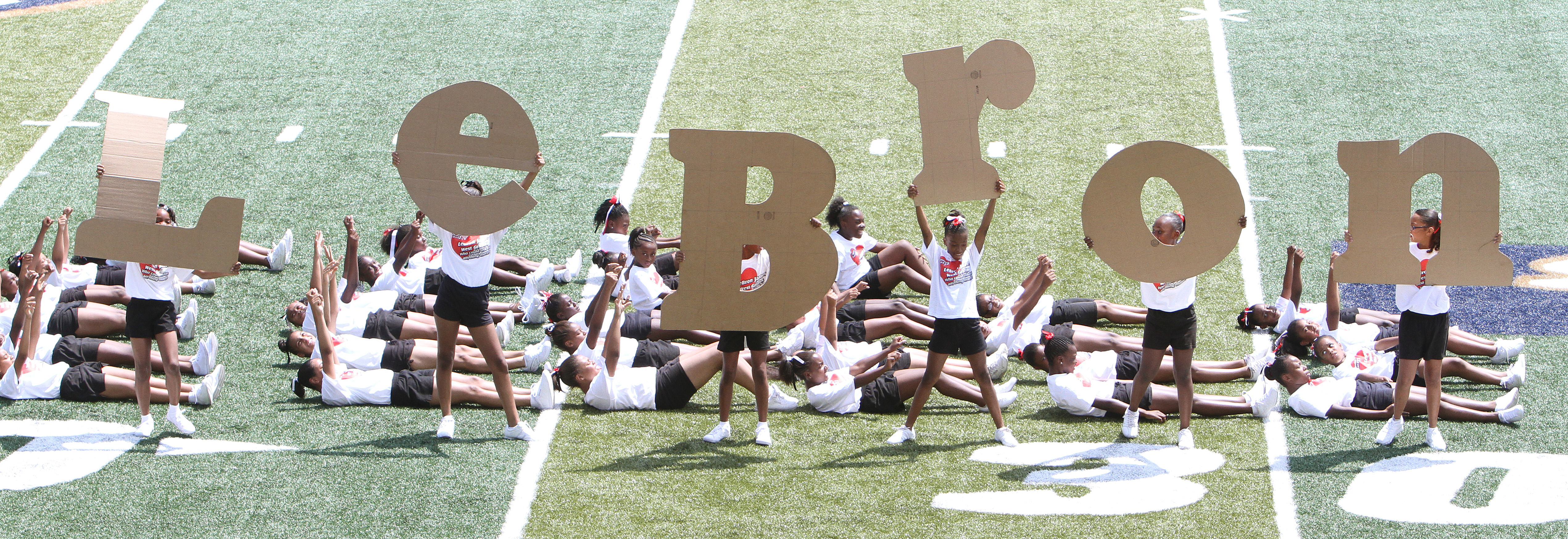 Akron West Griffins cheerleaders hold up letters that spell out LeBron at the end of their dance routine on the field of Akron University's InfoCision Stadium June 19, 2010 during the LeBron James Appreciation Day rally.  Cavs fans were hoping to persuade James in staying with the Cavs during his free agency quest starting July 1, 2010.  (John Kuntz / The Plain Dealer)