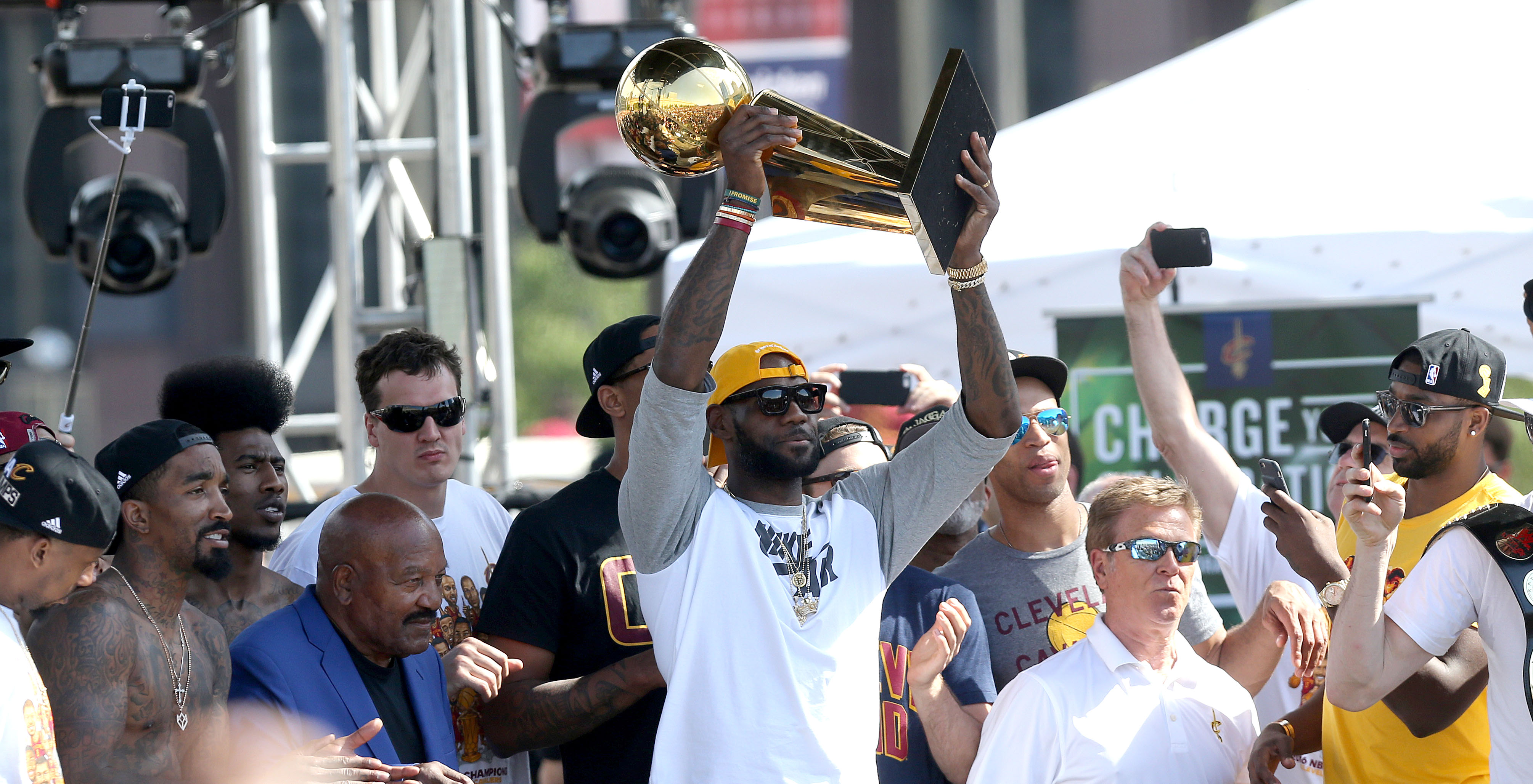 Cleveland Cavaliers forward LeBron James hoists the  Larry O'Brien trophy into the air after having it handed to him by Jim Brown at a rally to celebrate and honor the 2016 NBA Champion Cleveland Cavaliers.    Joshua Gunter, cleveland.com June 22, 2016. Cleveland.