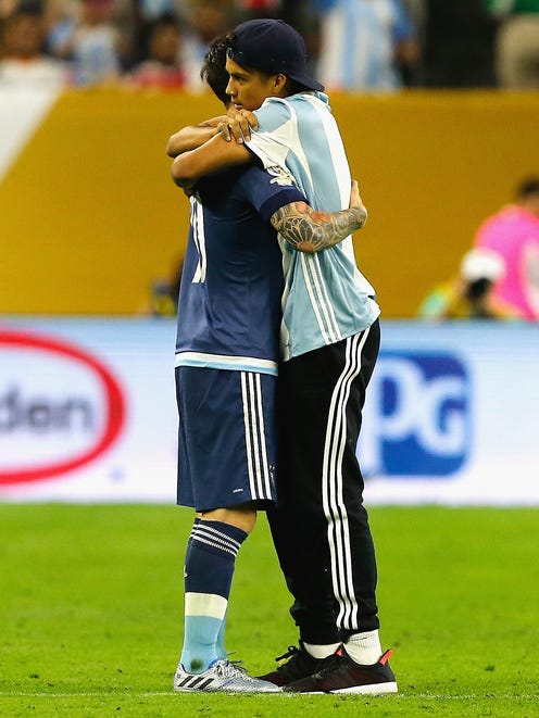 Messi and the fan hugged on the pitch.