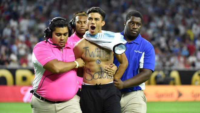 Eventually security caught the fan and escorted him off the field as he yells in celebration.